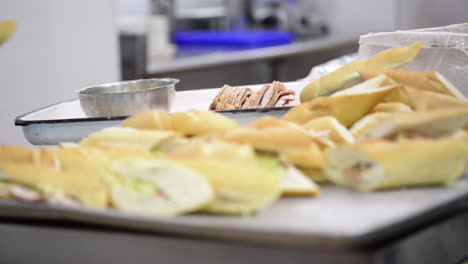 close up of hands preparing sandwich with gloves