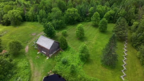 Reversing-aerial-view-of-John-Brown-Farm-Historic-Site-in-North-Elba,-New-York