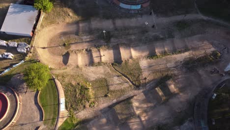 BMX-bicycle-on-dirt-track.-Aerial-directly-above