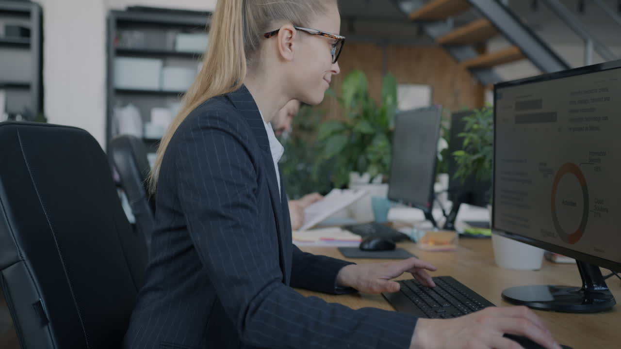 Businesswoman working on computer in modern office