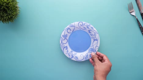 putting empty plate on table top view