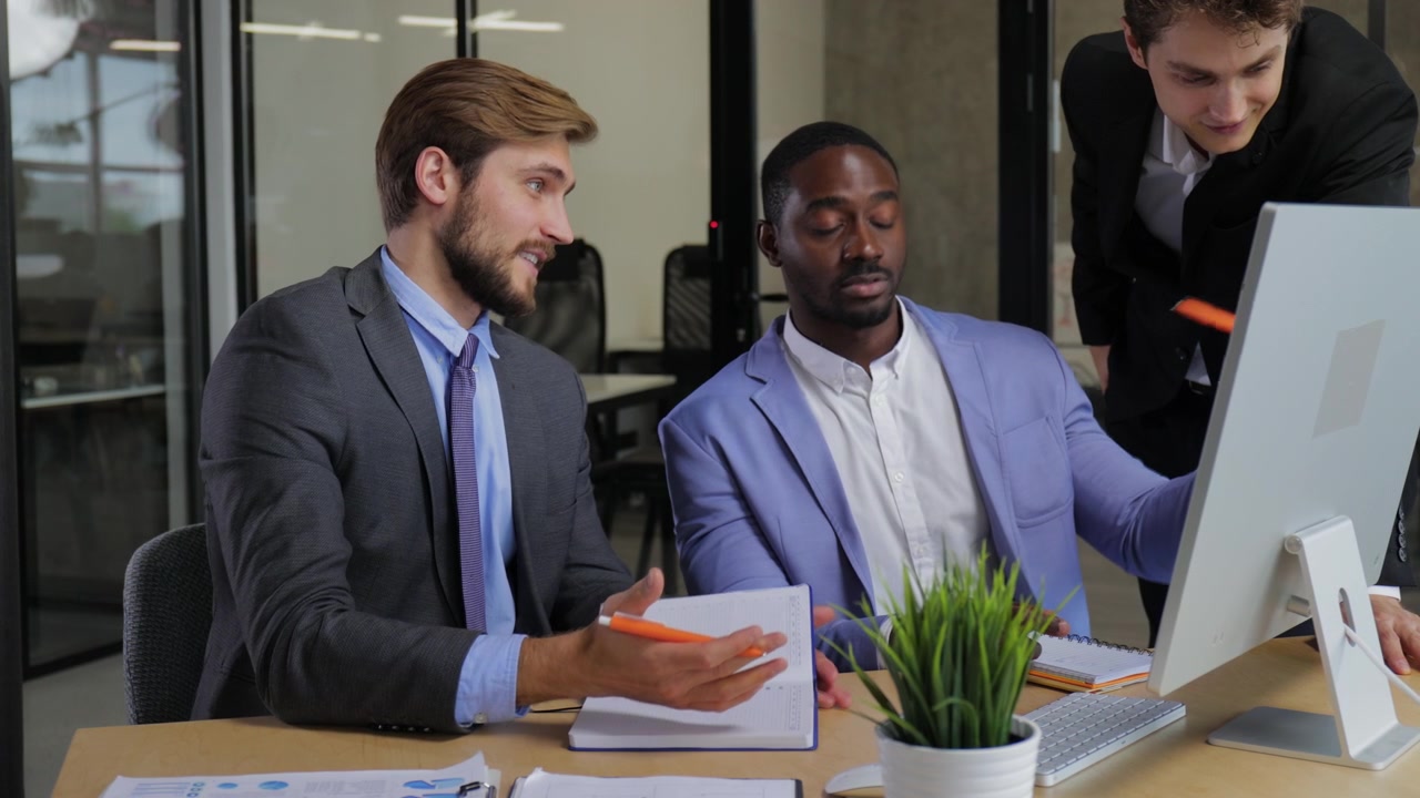Diverse Businessmen Collaborating and Discussing Project in Modern Office