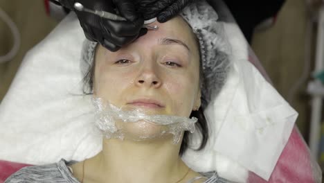 cosmetologist make facial cleaning cosmetology skin acne procedure on woman face