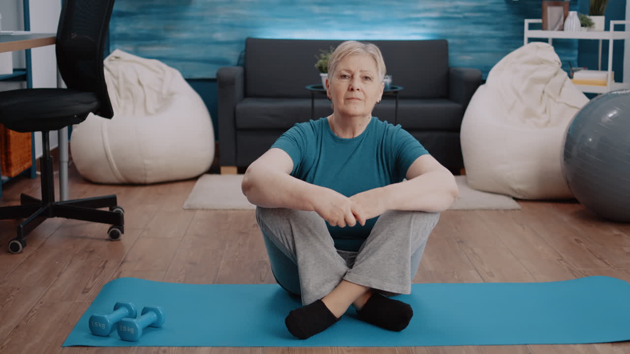 Portrait of senior woman preparing to workout at home