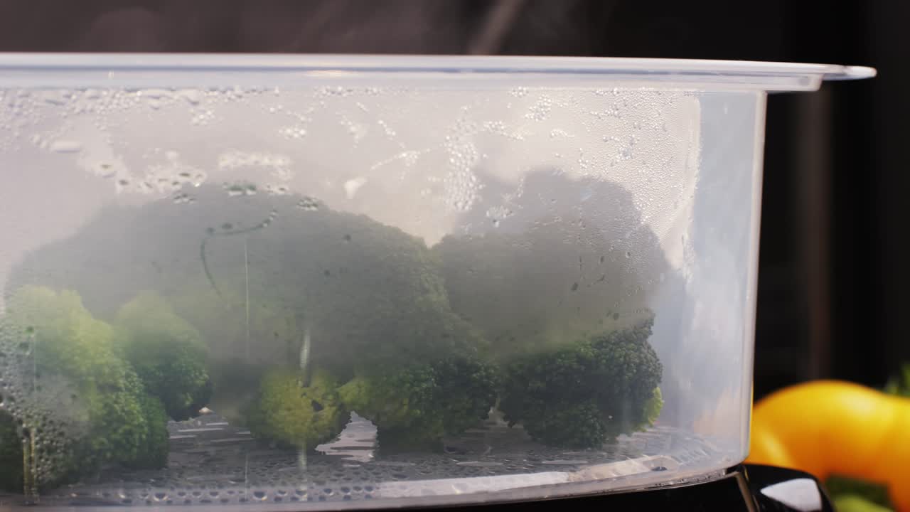 Mixed vegetables, carrots, broccoli, and cauliflower in a food double boiler steamer basket in a stainless steel pot, healthy diet cooking method preserving minerals, vitamins and flavor