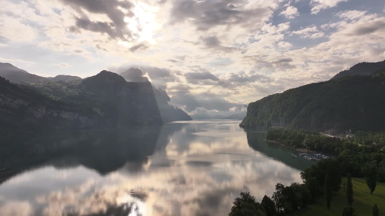serene morning light over calm walensee lake and alpine hills