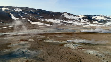 aerial, steam coming from the fumaroles and bubbling mud pits at hverir geothermal field, iceland