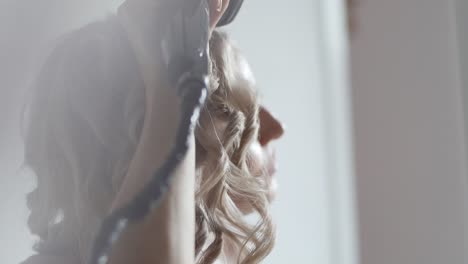 Woman-curling-hair-at-home