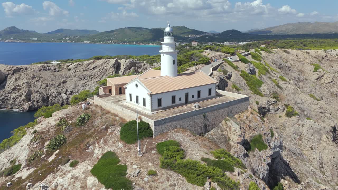 Capdepera Lighthouse on a rugged coastal cliff in Majorca Spain, aerial