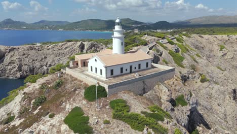 capdepera lighthouse on a rugged coastal cliff in majorca spain, aerial