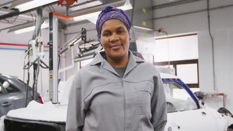 African-American-female-car-mechanic-looking-at-the-camera-and-smiling