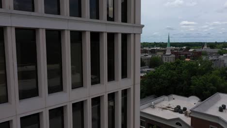 Aerial-shot-from-behind-a-building-in-Greenville-in-South-Carolina,-street-with-historic-buildings-on-a-cloudy-day