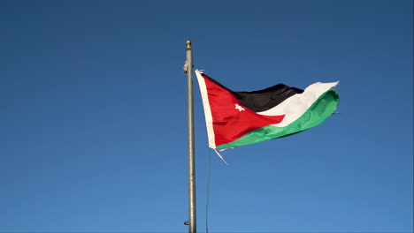 jordan flag waving in the wind against blue sky