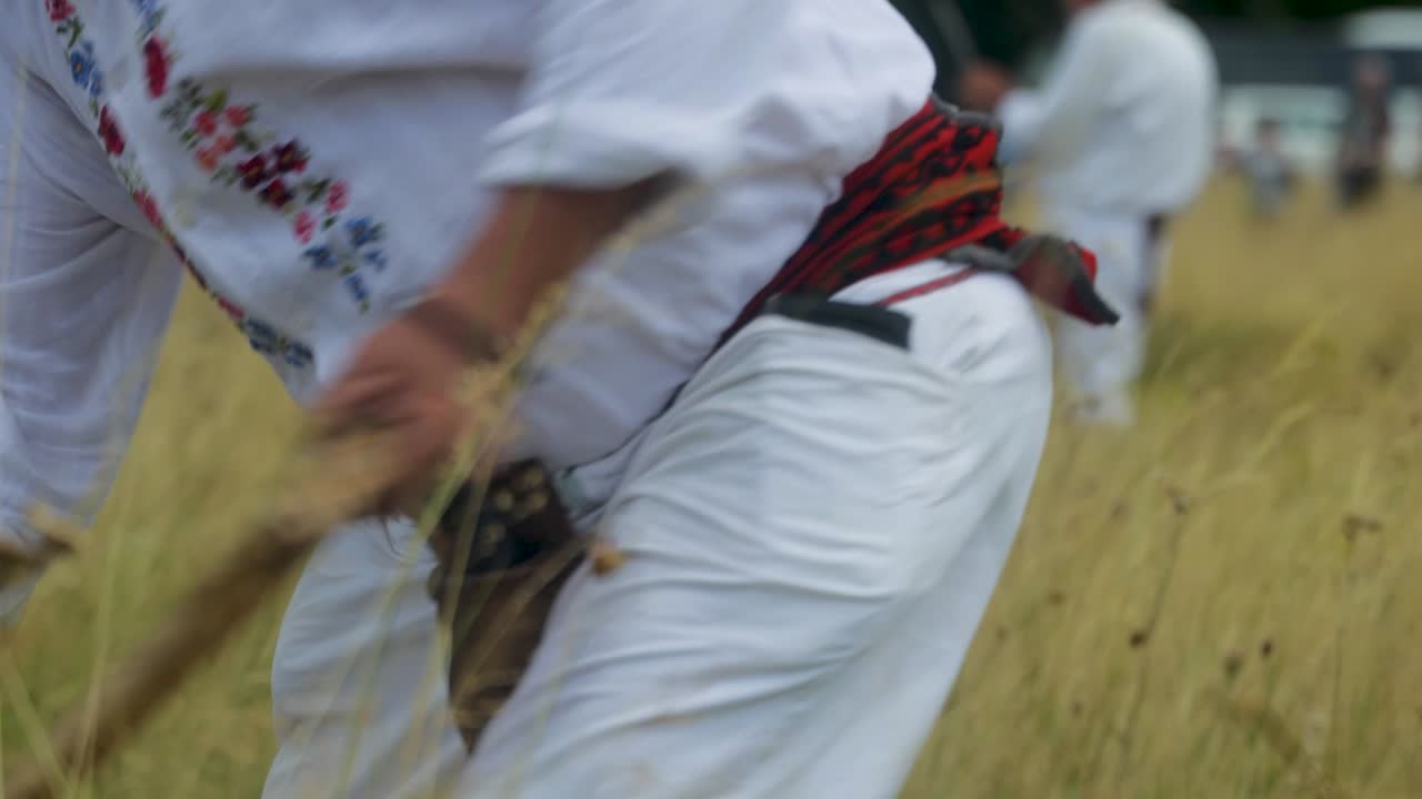A peasant working with a scythe in a field