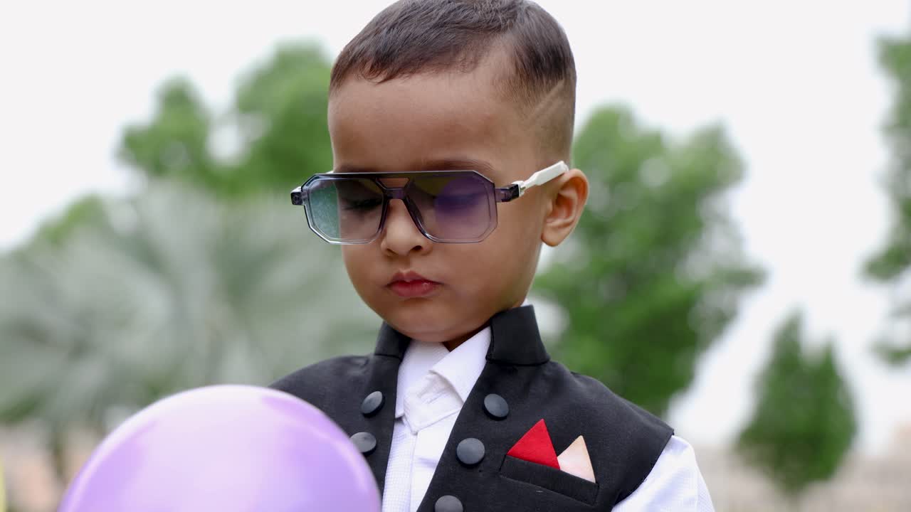 cute indian toddler with innocent smiling facial expression at outdoor
