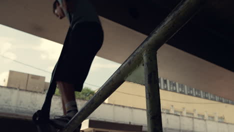 teenager showing jump tricks on scooter at urban skate park. man jumping on rail