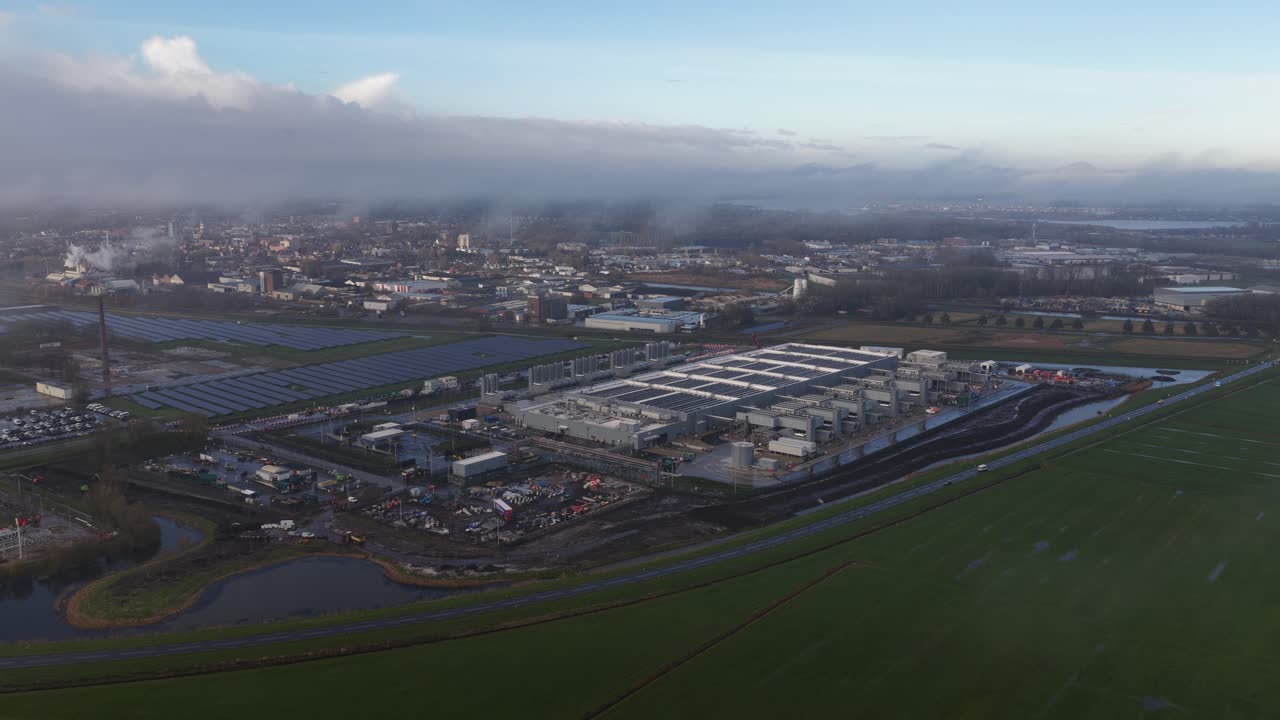 aerial drone footage of industrial data processing and computing at a large hyperscale data center in Winschoten, The Netherlands