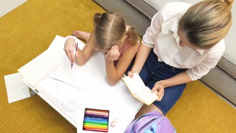 mother helping daughter with homework