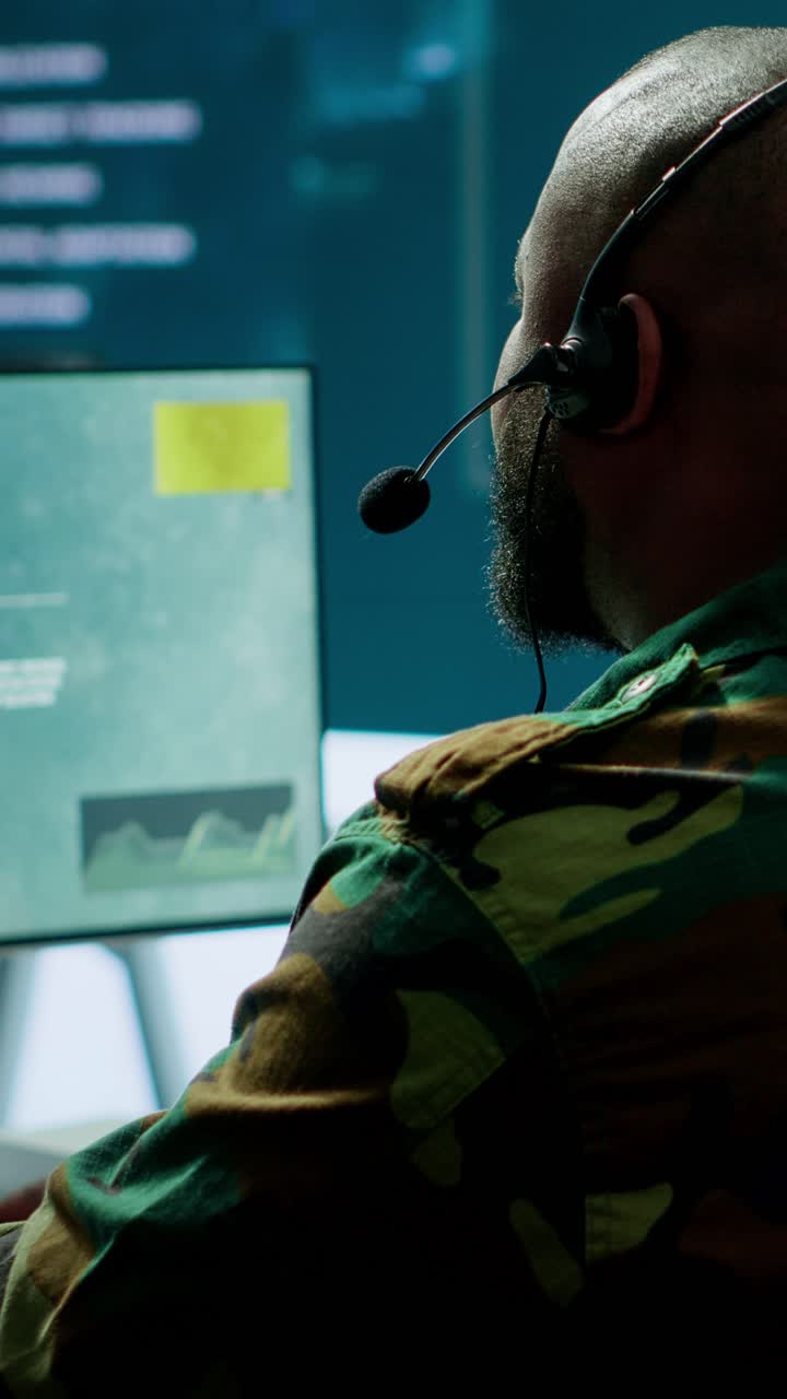 Vertical Video Military personnel in base of operations using advanced computers and big screen