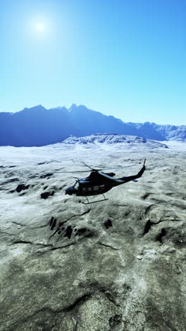 helicopter flying over desert mountains