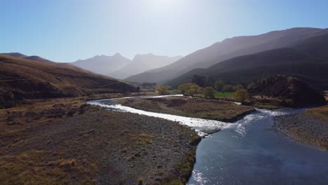 Aerial-view-of-fork-in-braided-river-flowing-from-mountains-in-autumn