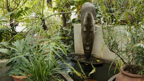 Scenic-ancient-garden-fountain-with-green-plants