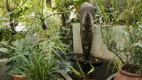 scenic ancient garden fountain with green plants