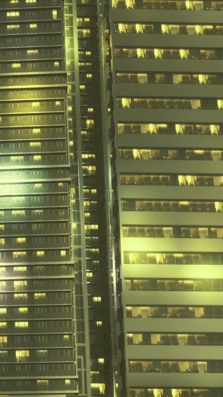 Night view of city buildings with lights shining in different windows