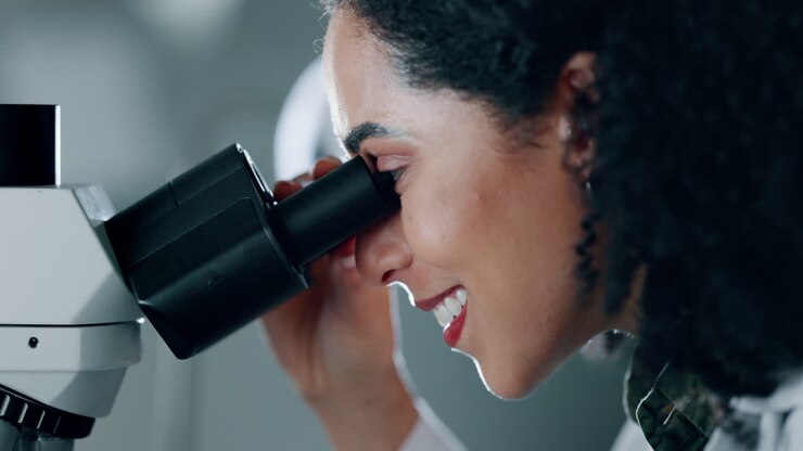 Medical, research and woman with microscope