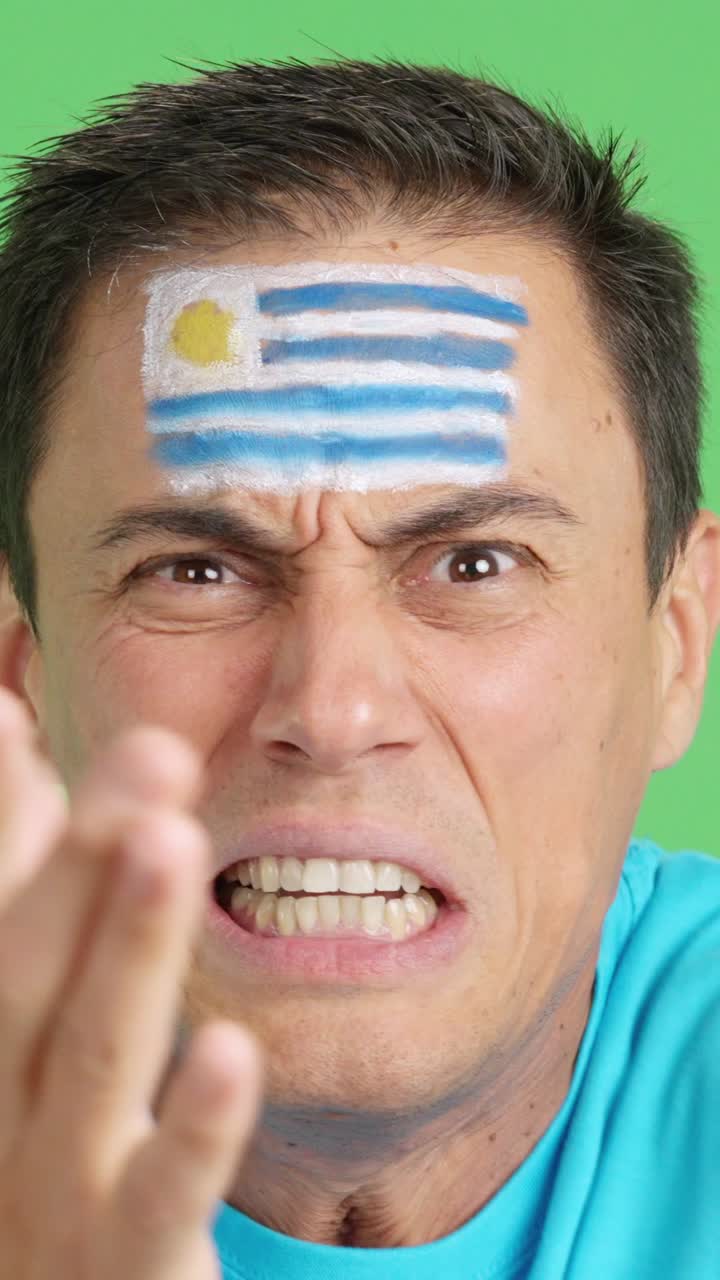 Man with uruguayan national flag upset with a referee