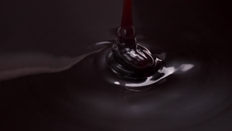 slow motion macro shot of melted chocolate being poured