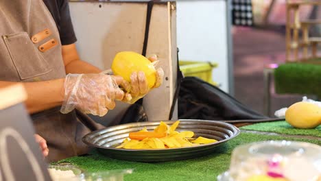 vendor slicing mangoes at a bustling market