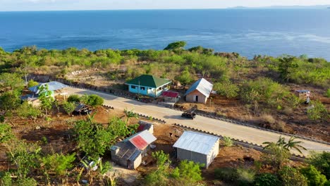 Aerial-view-of-road-and-cars-driving-on-coast-by-the-sea