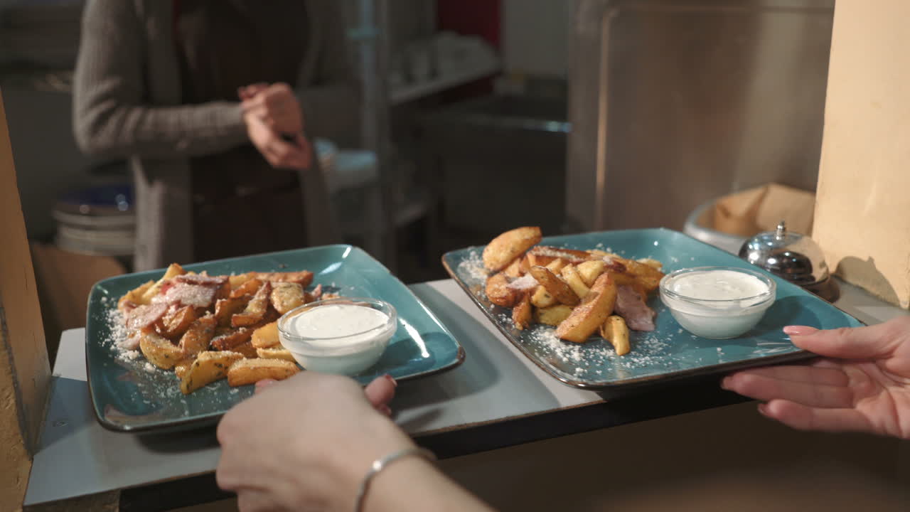 Restaurant Staff Serving Potato Wedges