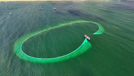 Drone-view-of-fishing-boat-is-netting-on-the-sea-of-Ke-Ga,-Binh-Thuan-province,-central-Vietnam