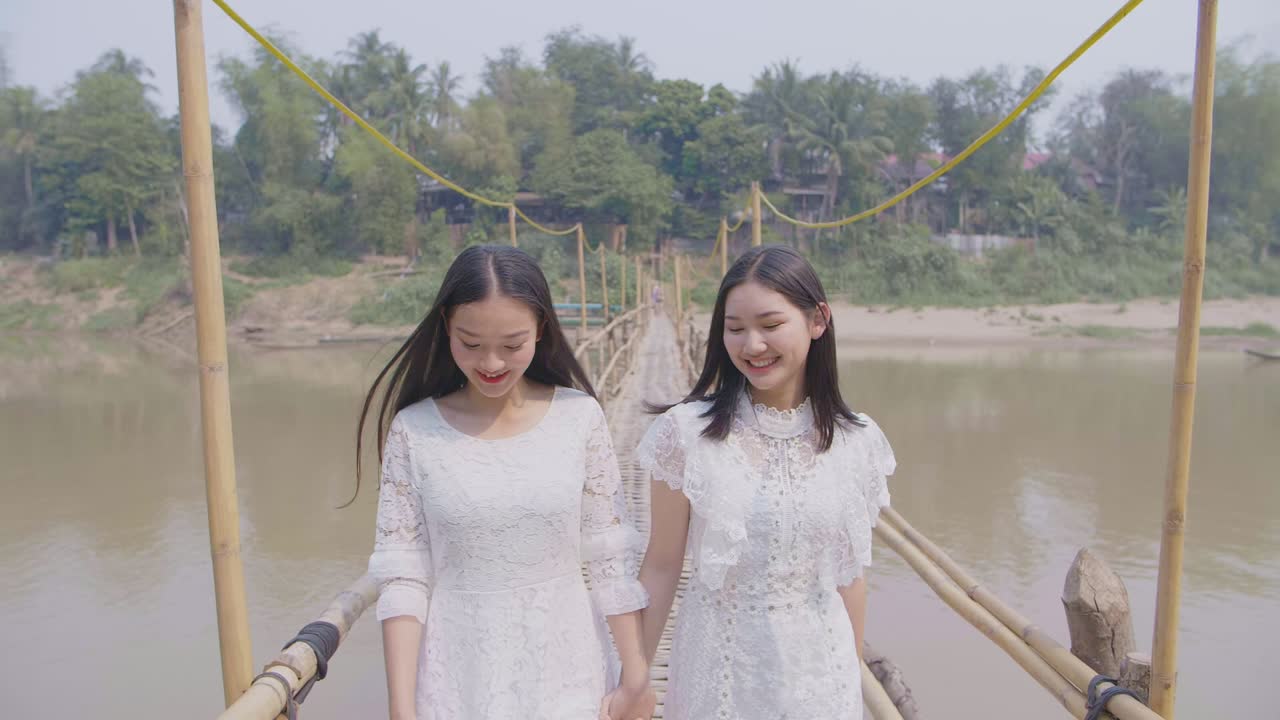Two Asian Girls Happy Walking On Bamboo Bridge, Slow Motion