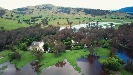 slow moving drone footage of the swollen floodplains of the mitta mitta river near where it enters lake hume, in north-east victoria, australia