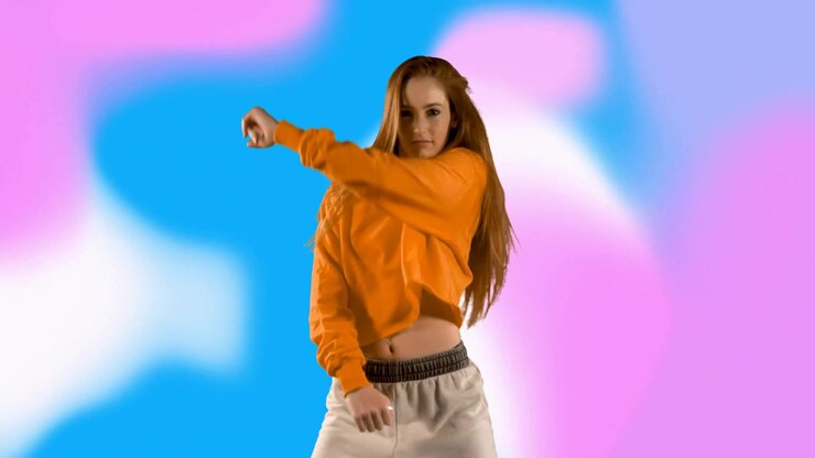 Young Woman Performing Energetic Dance Moves Against Colorful Abstract Background