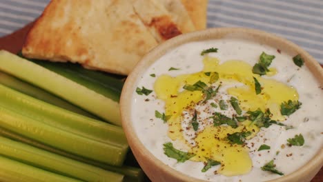 greek tzatziki sauce of salted strained yogurt or diluted yogurt mixed with cucumbers and mint, garlic, salt, olive oil on top. high quality 4k footage