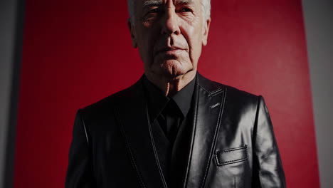 senior man in black leather jacket and suit