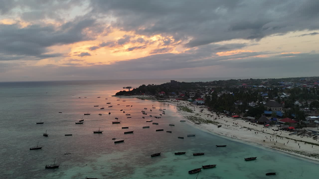 puesta de sol dorada sobre la isla de zanzíbar con aguas turquesas y arrecifes de coral en áfrica