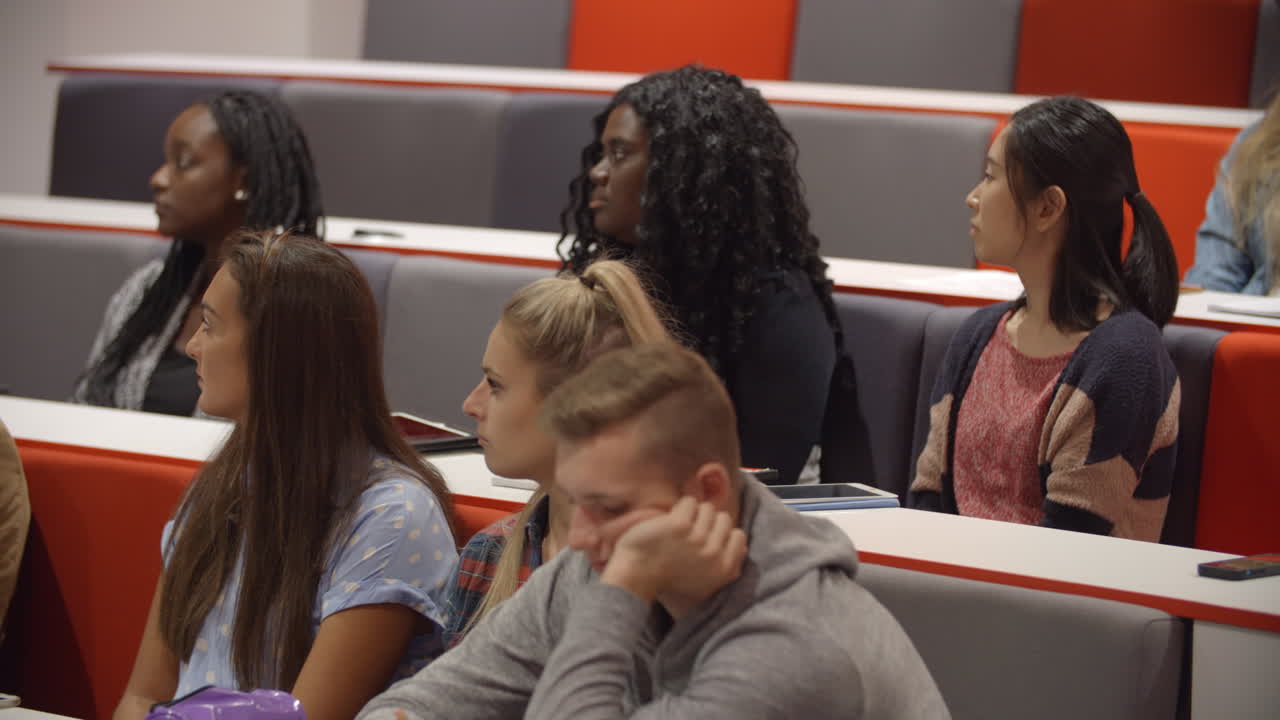 Close up of students sitting in a university lecture theatre
