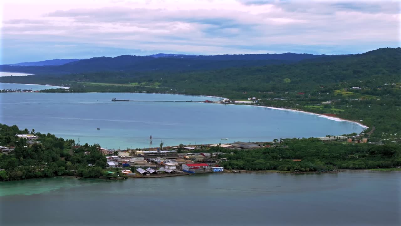 Sunny morning Wewak Papua New Guinea aerial drone dry season Boram Road Memorial drive Wewak Hill costal town Wewak Seawall Mini Beach Dogreto Bay shipwreck Sundaun Market car traffic static shot