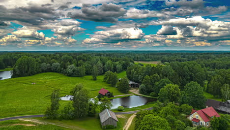 Aerial-time-lapse-nature-forest-landscape,-houses-in-village-during-summer