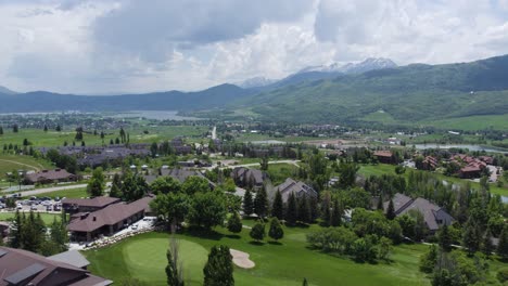 Aerial-trucking-pan-above-wolf-creek-golf-course,-luxury-homes,-utah