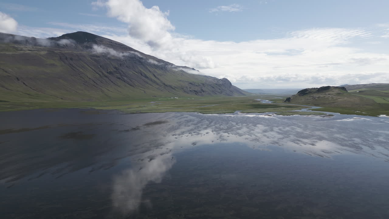 Calm lake view by mountains at Vatnsdalshólar, Iceland in clear weather