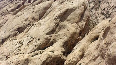 An-aerial-cinematic-footage-capturing-the-stunning-sandstone-rock-formations-in-the-desert-glowing-under-the-warm-colors-of-sunset