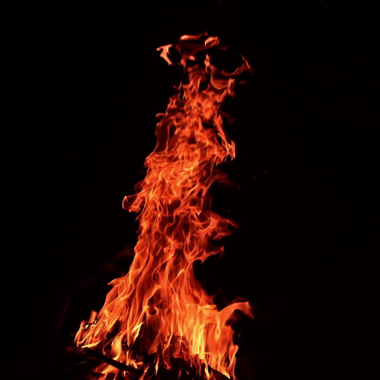 Burning campfire flaming motion. Flame glowing on black