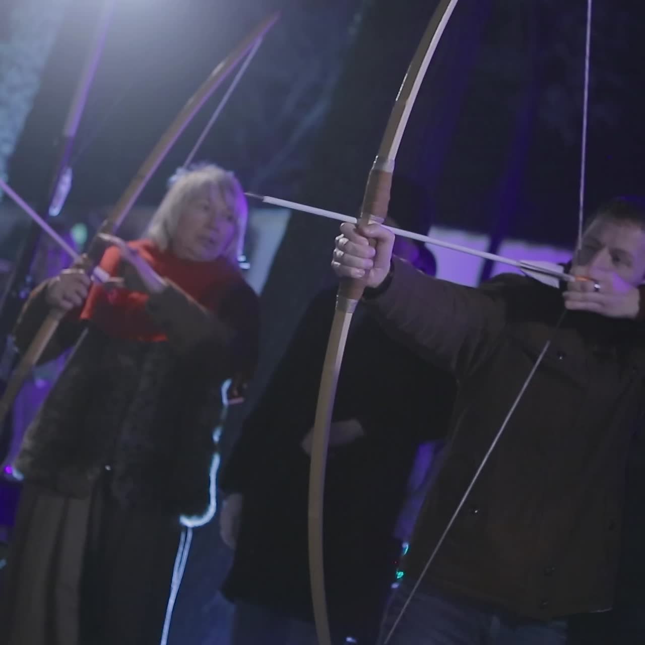 Man Aims A Bow At A Target