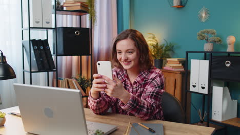 business woman waves hand hello gesture greeting welcomes someone on smartphone online webinar